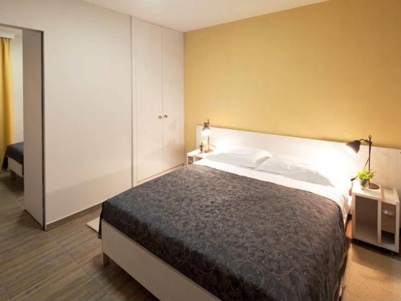 Cozy bedroom with double bed, nightstands, and large wardrobe.