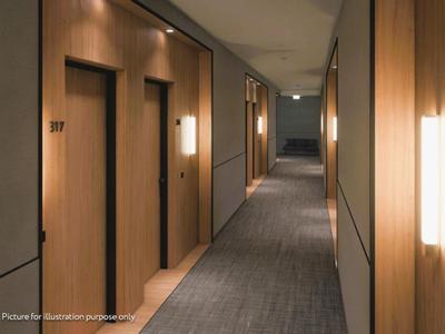 Gang met houten deuren en zachte verlichting in een modern hotel