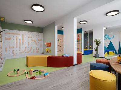 Heldere speelruimte in hotel met kleurrijke zitplaatsen en wanddecoraties voor kinderen.