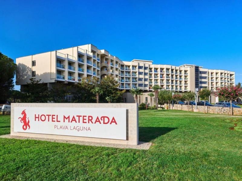 Modern hotel building with multi-story balconies and a sign reading Hotel Materada