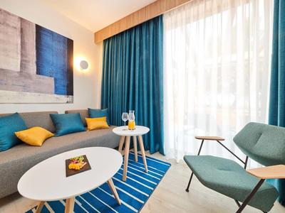 Soggiorno moderno con accenti blu e gialli, tavolino e luce naturale