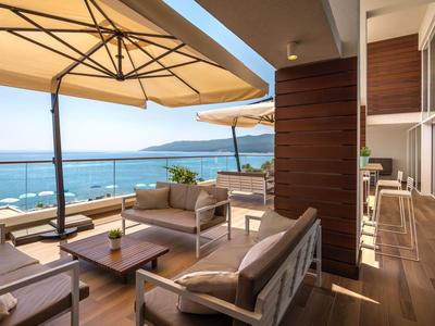 Elegante balkon met loungemeubilair met uitzicht op zee bij zonnig weer