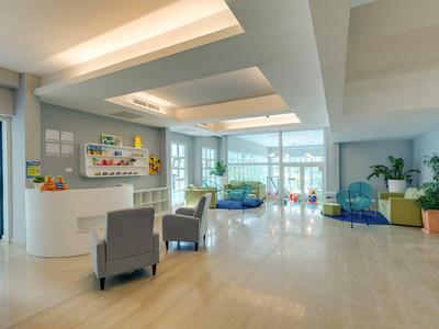 Hall d'hôtel lumineux et moderne avec des espaces sièges et de grandes fenêtres.