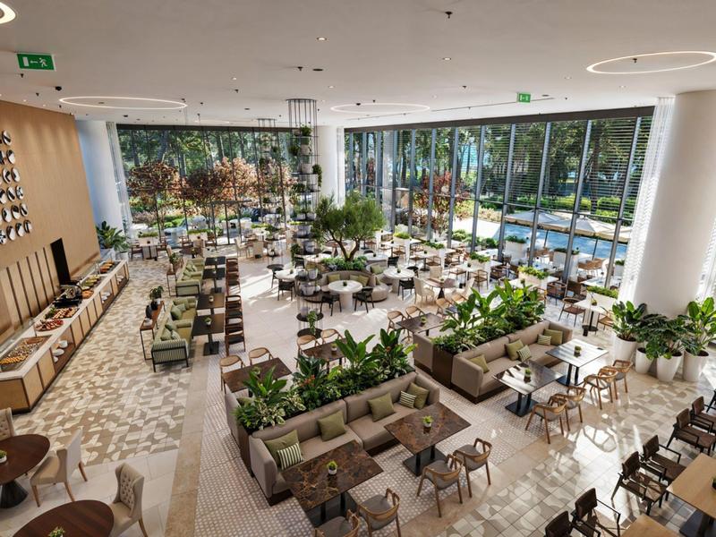 Modern hotel restaurant with large windows and plenty of natural light