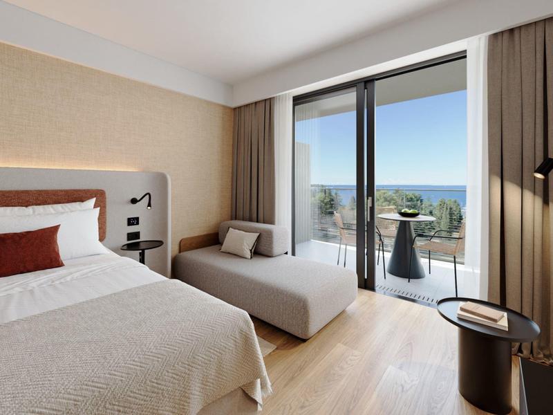 Bedroom with double bed and balcony with sea view in warm, neutral tones.