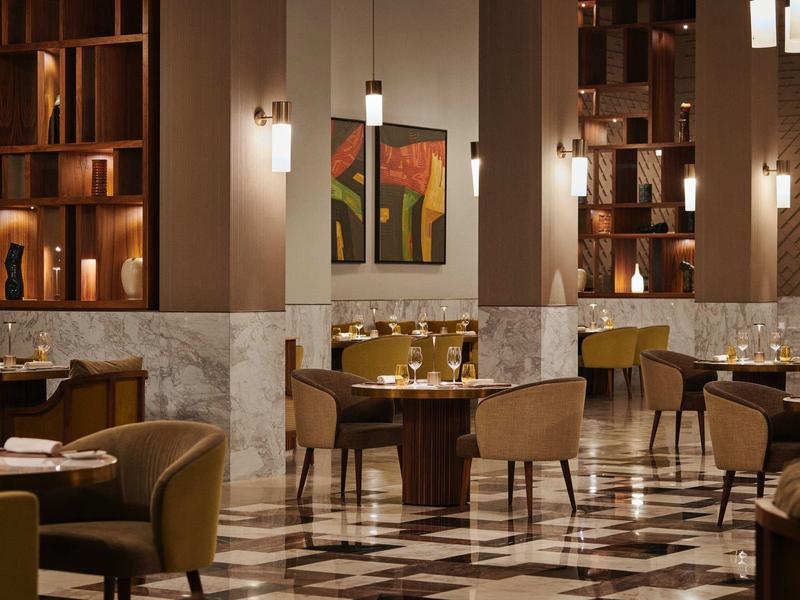 Elegant restaurant with marble floor, comfortable chairs, and soft lighting