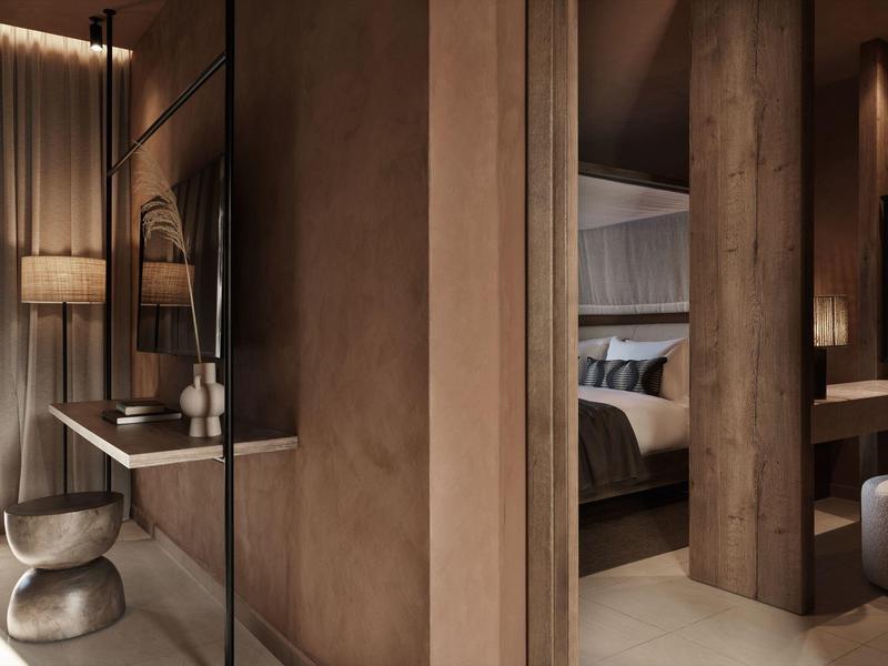 Habitación de hotel moderna con detalles de madera cálida y iluminación acogedora.