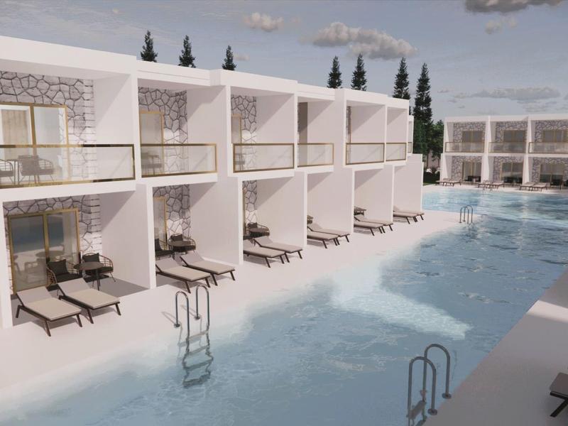 Moderner Pool mit weißen, rechteckigen Bungalows, Liegestühlen und klar blauem Wasser.