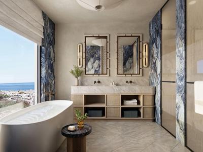 Salle de bains moderne avec baignoire indépendante, double vasque et vue sur la mer.