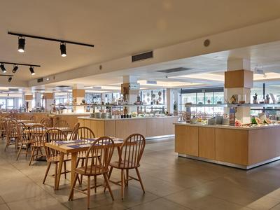 Modern dining area with wooden tables and chairs in a hotel