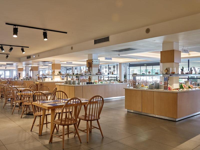 Modern dining area with wooden tables and chairs in a hotel