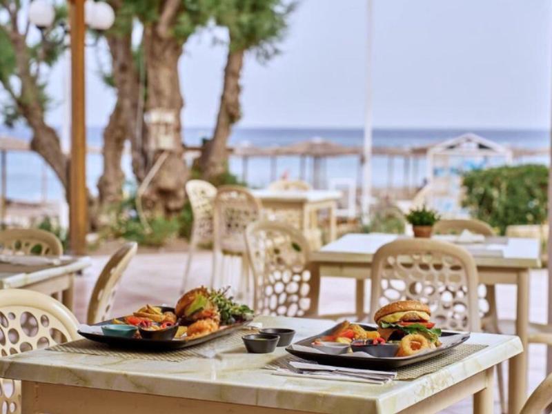 Outdoor terrace with set tables and a view of the sea
