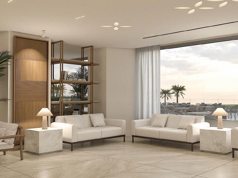 Bright modern living area with white sofas, large windows, and views of palm trees and water.