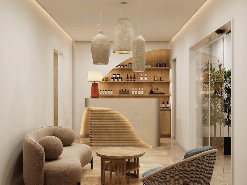 Modernes, gemütliches Hotelinterieur mit hellen Wänden, Sofas und Designelementen in warmen Tönen.