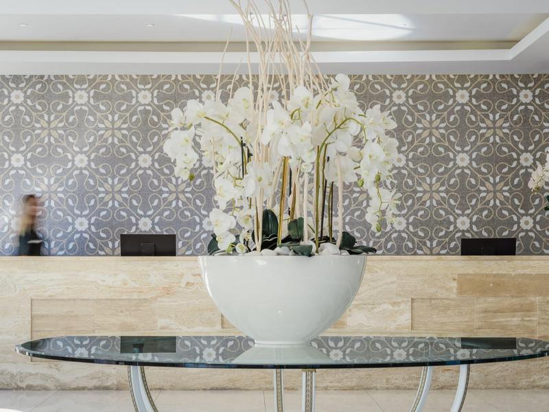 Elegante Hotellobby mit Blumentopf und stilvoller Rezeption im Hintergrund