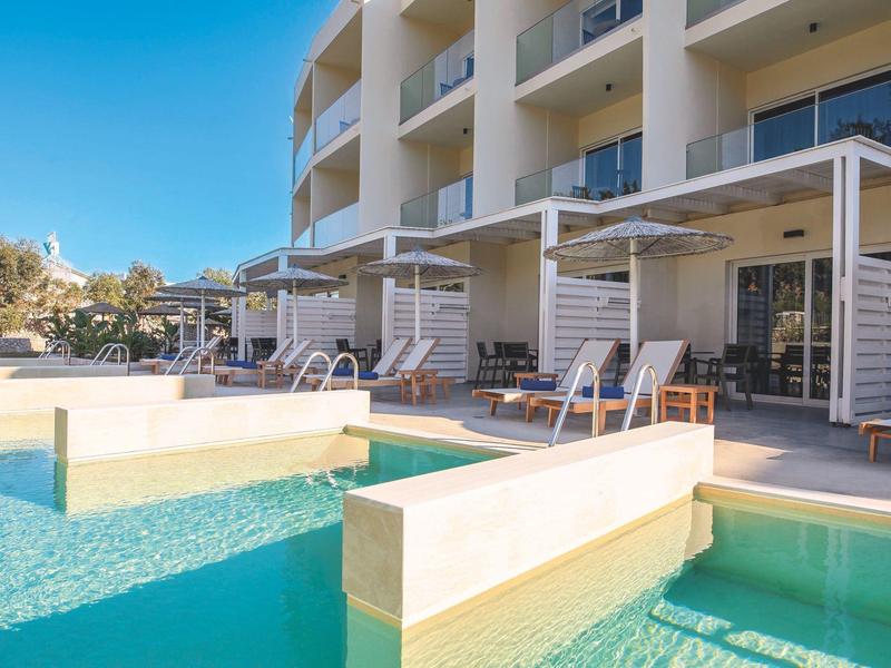 Moderner Hotelpoolbereich mit Liegestühlen und Glasgeländern an sonnigem Tag.