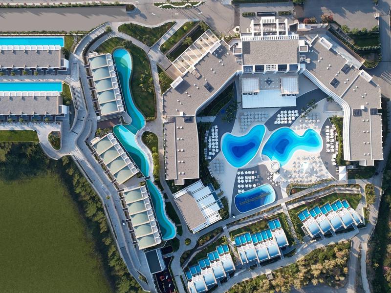Aerial view of a large hotel complex with multiple pools and buildings.