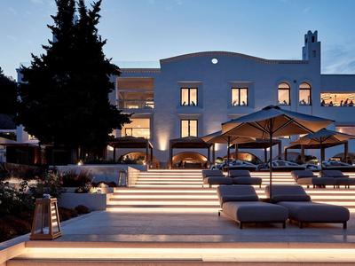 Hotel moderno con scale illuminate e lettini al crepuscolo