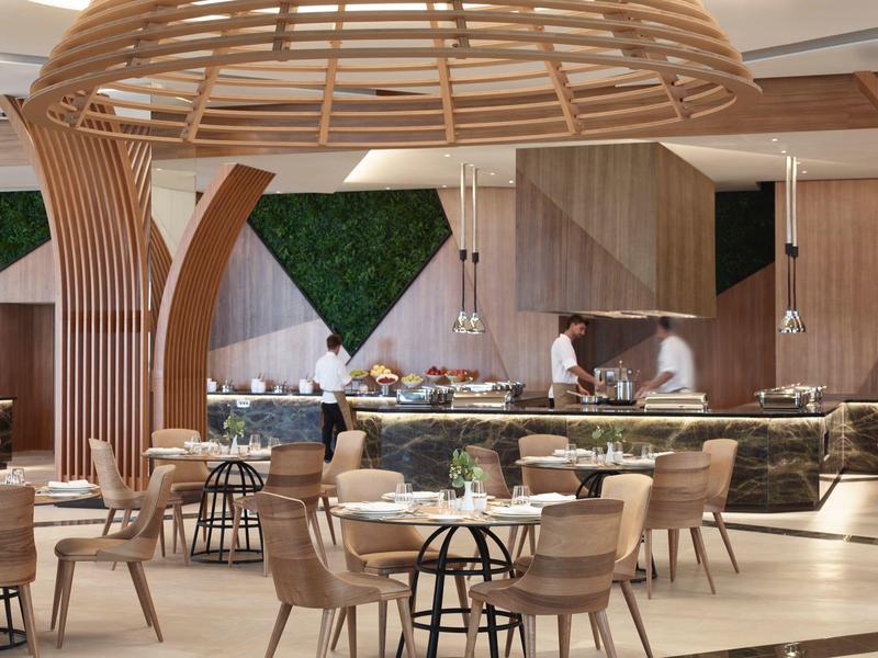 Ristorante moderno e spazioso con mobili in legno e design unico del soffitto in legno.