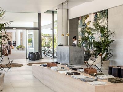 Area reception moderna di un hotel con interno elegante e piante.