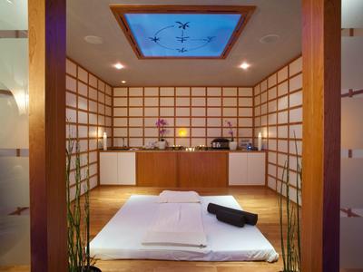 A tranquil massage room with traditional Japanese design and soft lighting.