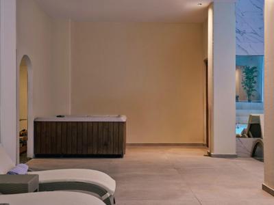 Modern spa room with lounge chairs and wooden furniture in warmly lit space