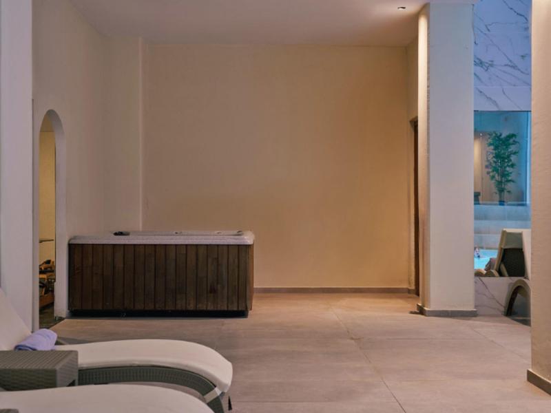 Modern spa room with lounge chairs and wooden furniture in warmly lit space