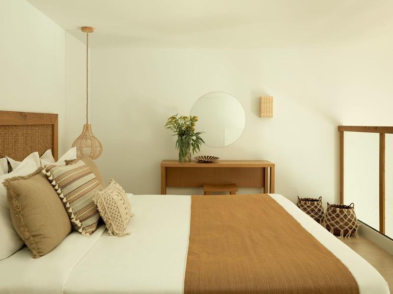 Brightly decorated hotel room with large bed and brown accents.