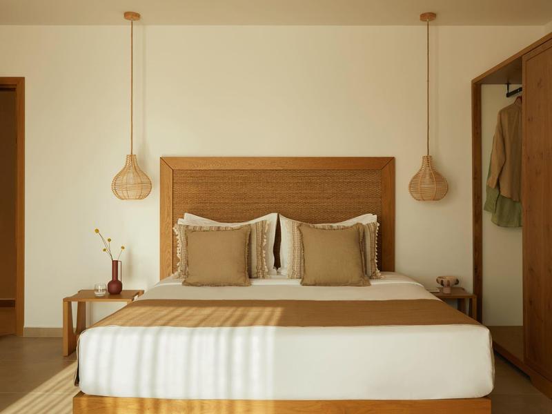 Cozy hotel room with beige and brown tones and minimalist design.