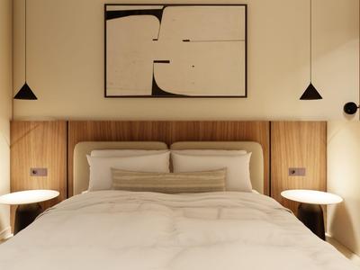 Modern hotel room with large bed, wooden wall, and abstract artwork.