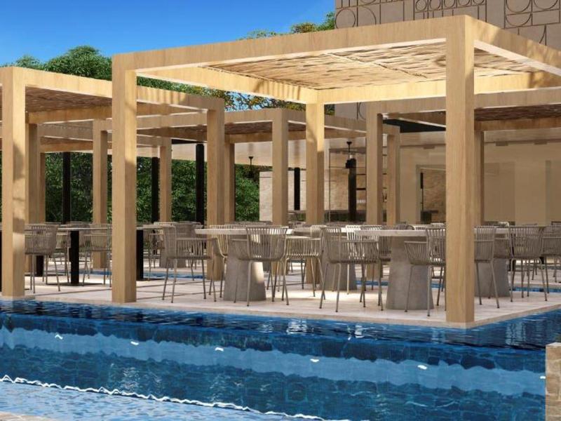 Modern outdoor area with wooden pergolas and a blue pool in front of a hotel building.