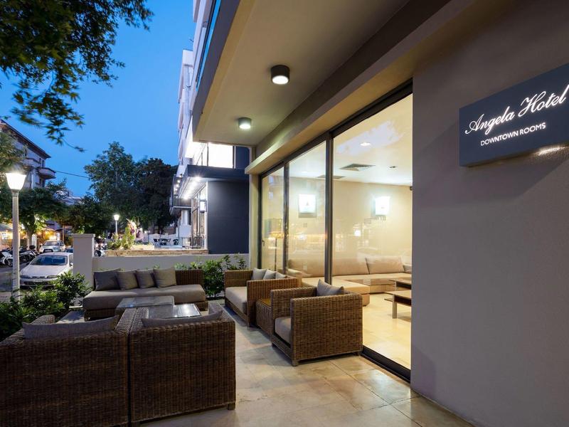 Outdoor seating area of a modern hotel with rattan furniture in the evening.
