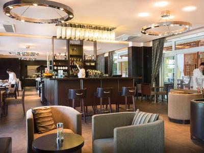 Moderní hotelový bar s pohodlnými křesly a stylovým zařízením.