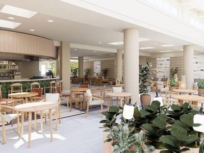 Heller Hotel-Loungebereich mit Tischen, Stühlen und einer Bar im Hintergrund.