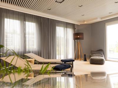 Bright, modern wellness room with lounge chairs, comfortable bean bags, and large windows.