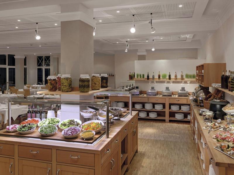 Large dining room with buffet and various dishes in a hotel.