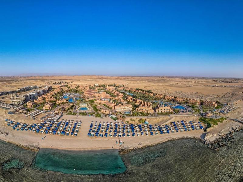 Panoramisch uitzicht op een strandhotelresort met parasols en kliffen aan zee