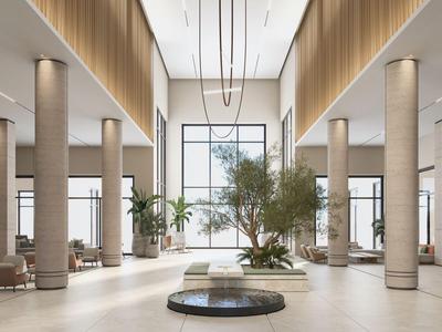 Großer Hotellobby mit hohen Decken, Säulen und Sitzbereichen, hell und modern gestaltet.
