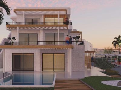 Bâtiment hôtelier moderne avec grandes terrasses, piscine et palmiers au coucher du soleil.