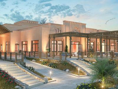 Bâtiment d'hôtel moderne avec grande terrasse et éclairage extérieur au coucher du soleil.