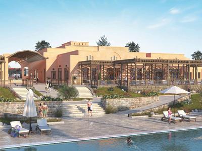 Hôtel de luxe avec architecture moderne, piscine et parasols au bord de l'eau.