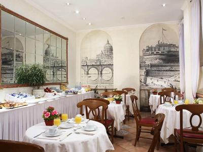 Elegant dining room with white-clothed tables and large wall murals in a hotel.