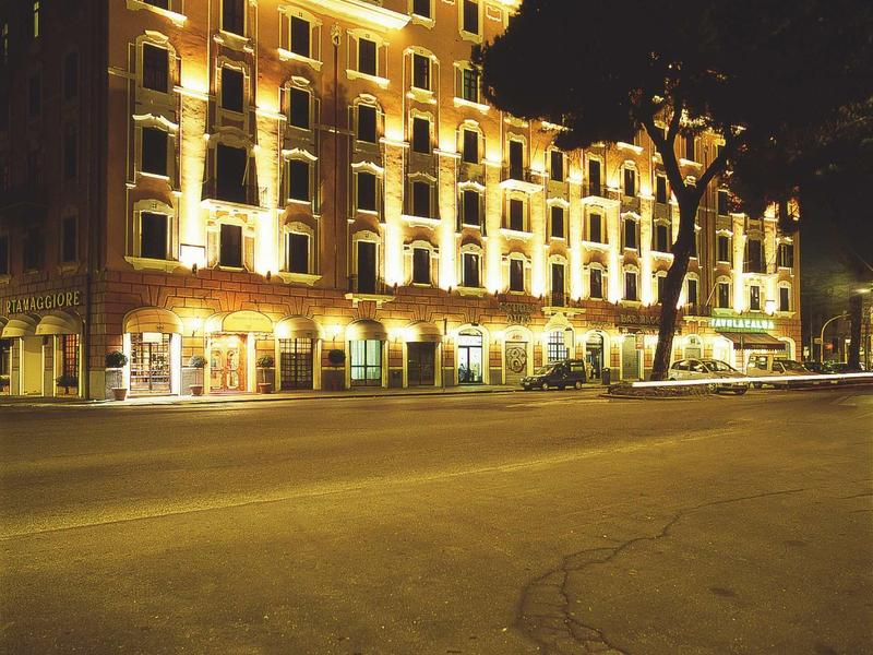 Illuminated multi-story hotel building with windows at night