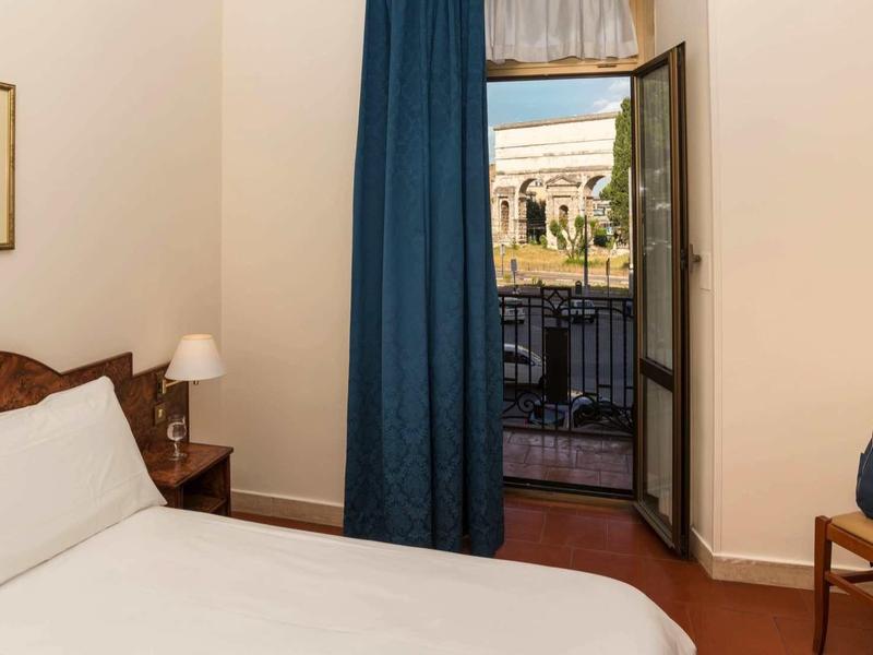 Cozy hotel room with a view of historic balcony and buildings