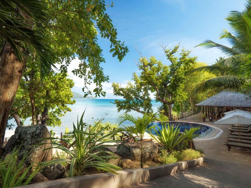 Tropical garden with a view of the beach and sea.