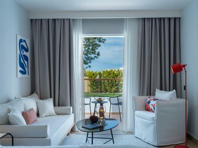 Modern living room with gray curtains and view of terrace and garden.