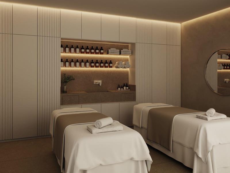 Modern spa room with two massage tables and ambient lighting