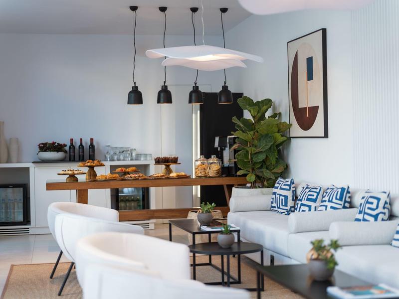 Modern living room with sofa, dining table, and minimalist decor.