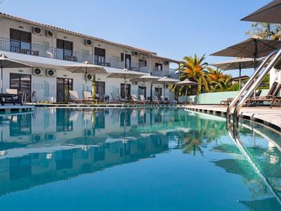 Modern hotel pool with sun loungers and umbrellas on a sunny day