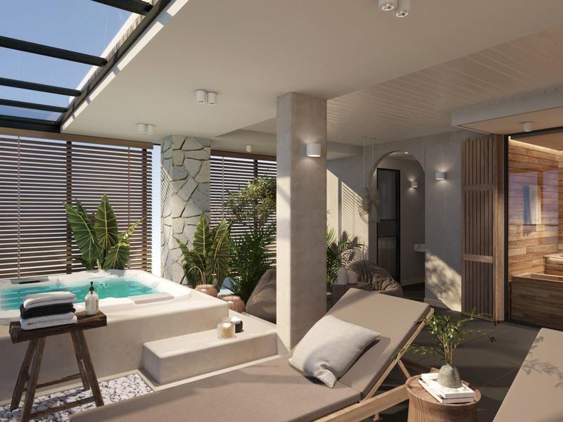 Nowoczesna strefa wellness z jacuzzi, leżakami i sauną w świetle dziennym.